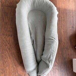 Baby with sage linen cover